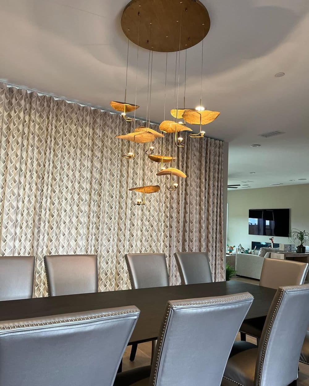 Modern dining room with stylish pendant lights and elegant furniture.